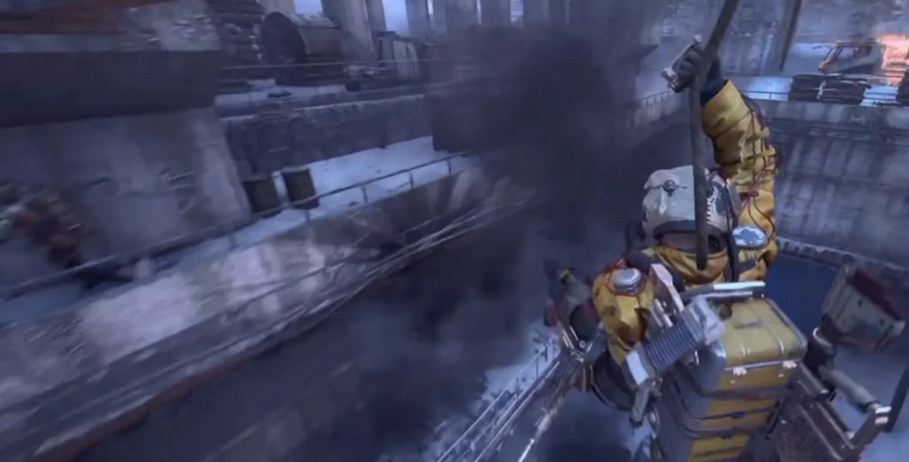 A raider in a yellow suit hanging from a rope above a ruined industrial structure in ARC Raiders