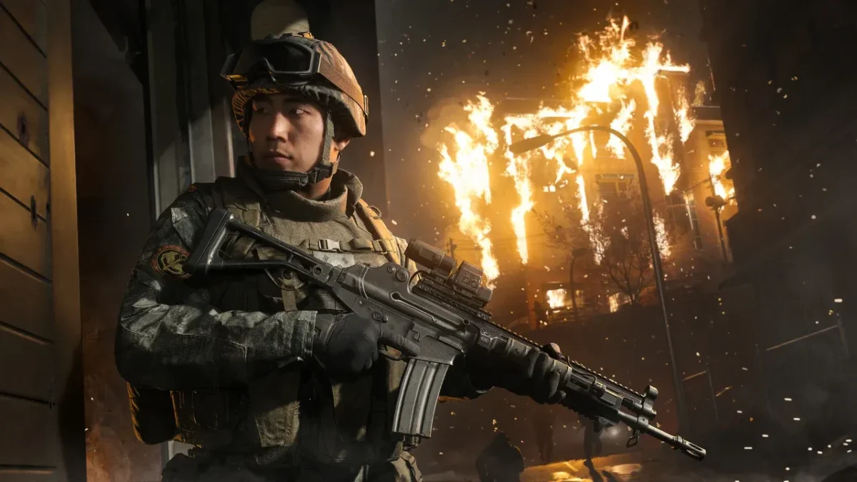 A soldier with an assault rifle in front of a burning building in Call of Duty: Modern Warfare 4