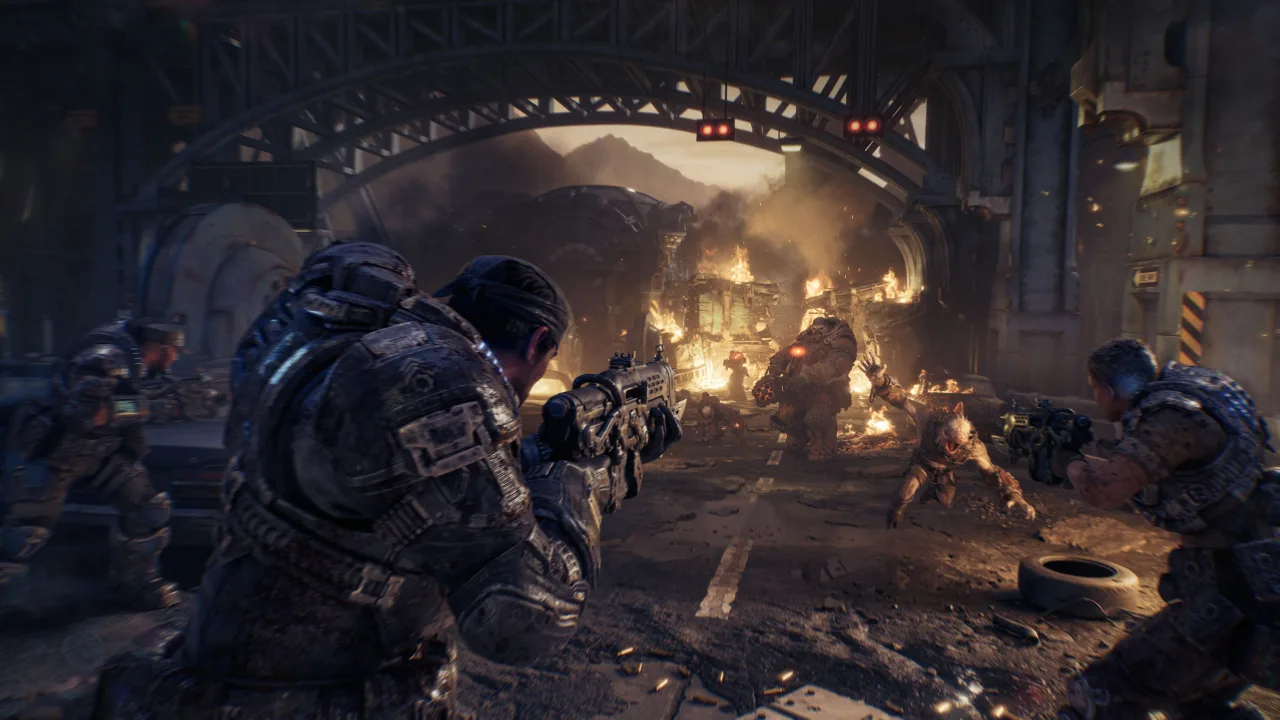 Gears of War: E-Day Bravo Squad firing on a Boomer and a Wretch under a burning bridge