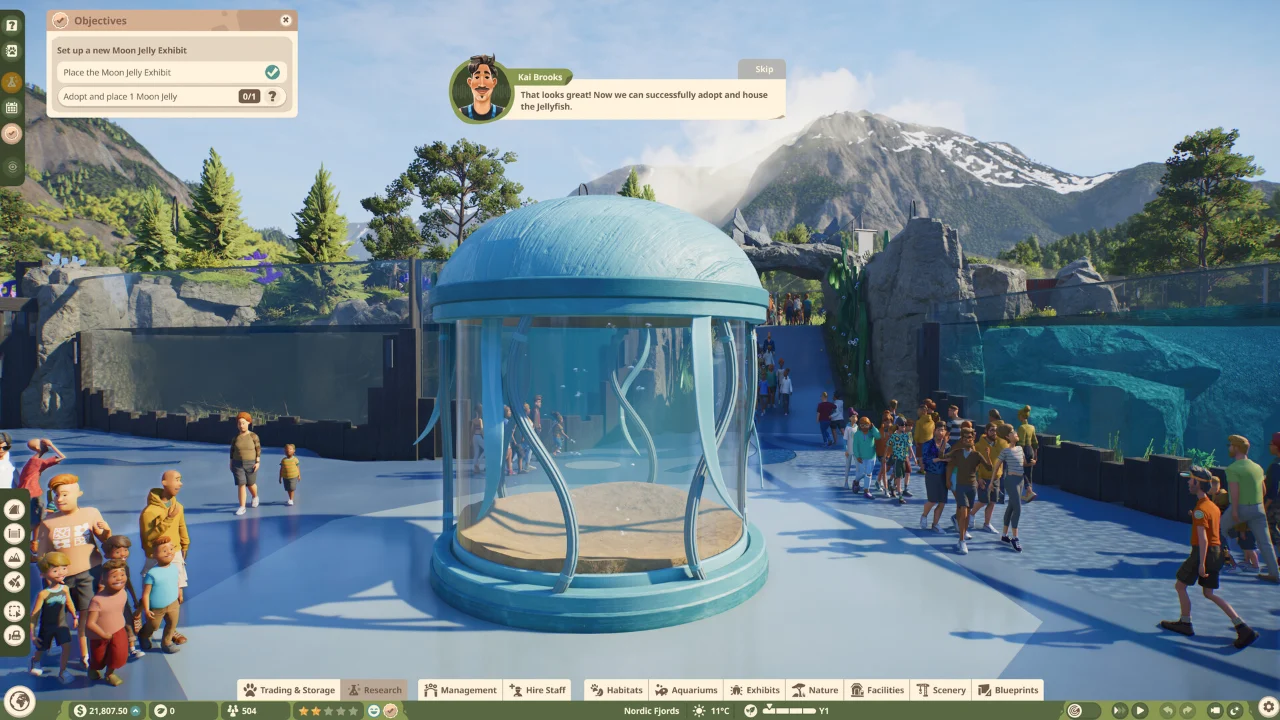 A crowd of guests gathered around a glass dome exhibit in Planet Zoo 2